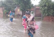 भीषण बाढ़ के पानी में घुसकर भाईयों के घर जा रहीं बहनें